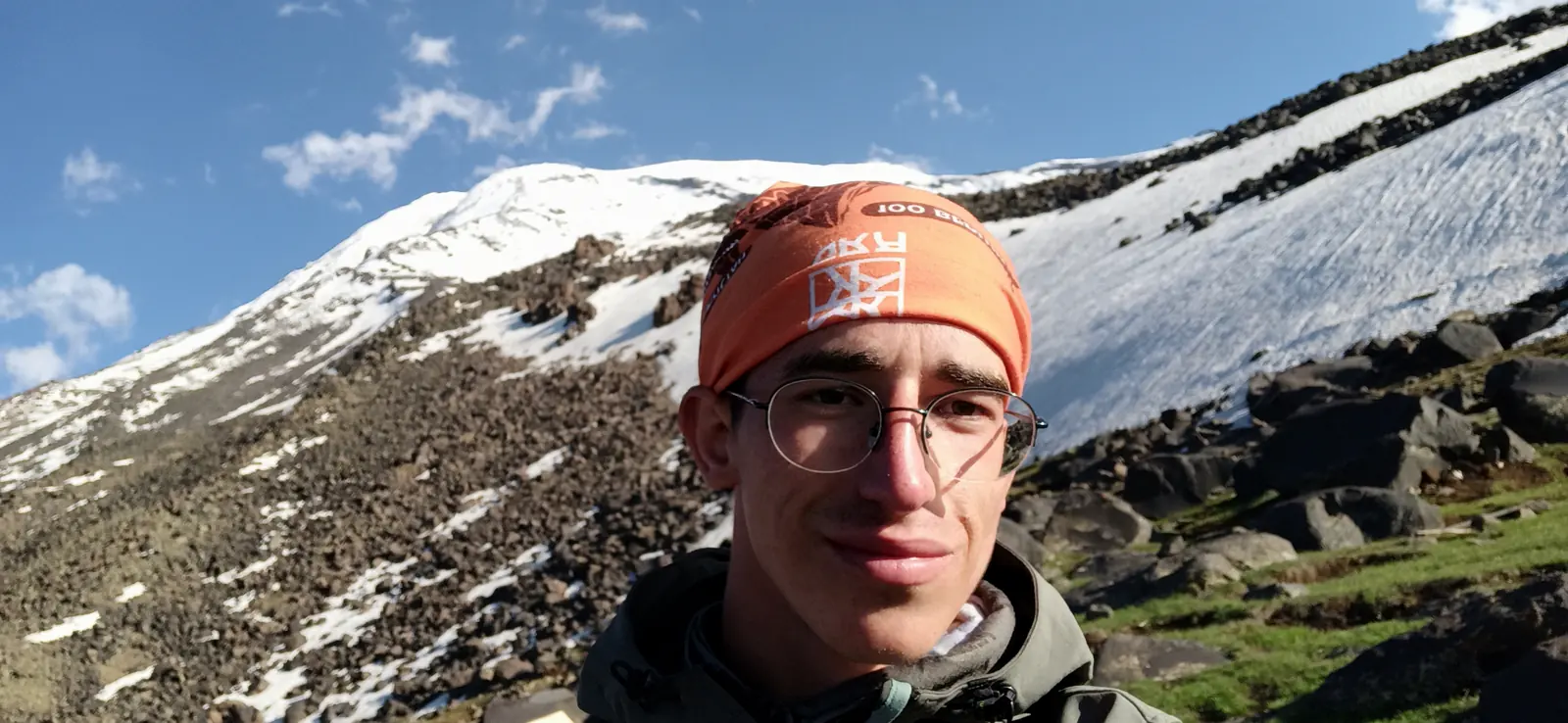 Andrii in an orange headband, with the snowy slopes of Ararat behind him