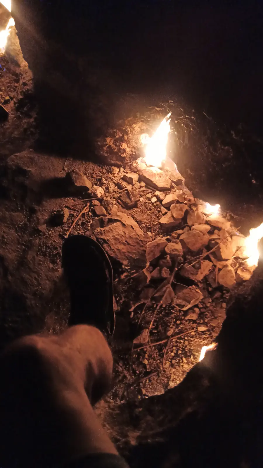 Flames glowing inside a hollow in dark rock