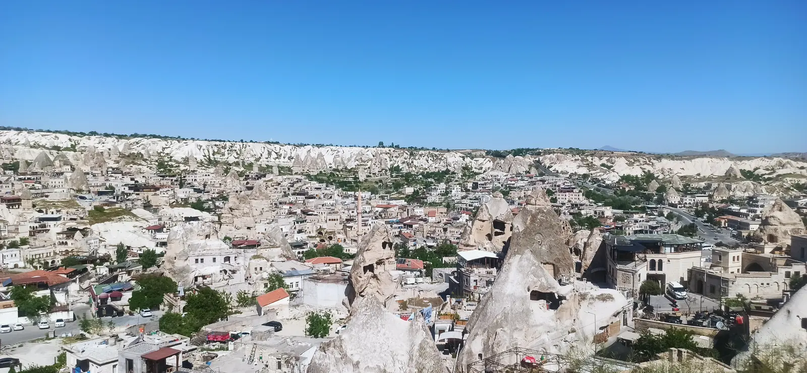 A town of pale houses built among carved rock formations