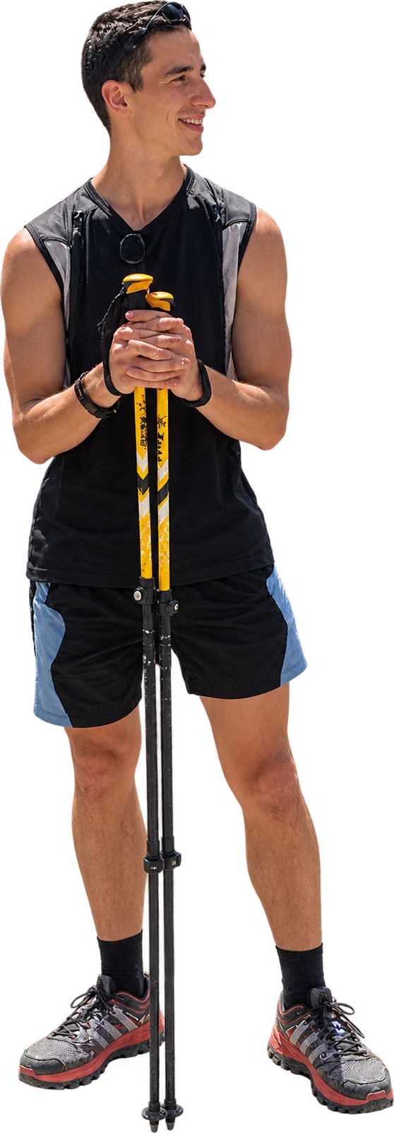 Me, smiling, leaning on my trekking poles, in running shoes
